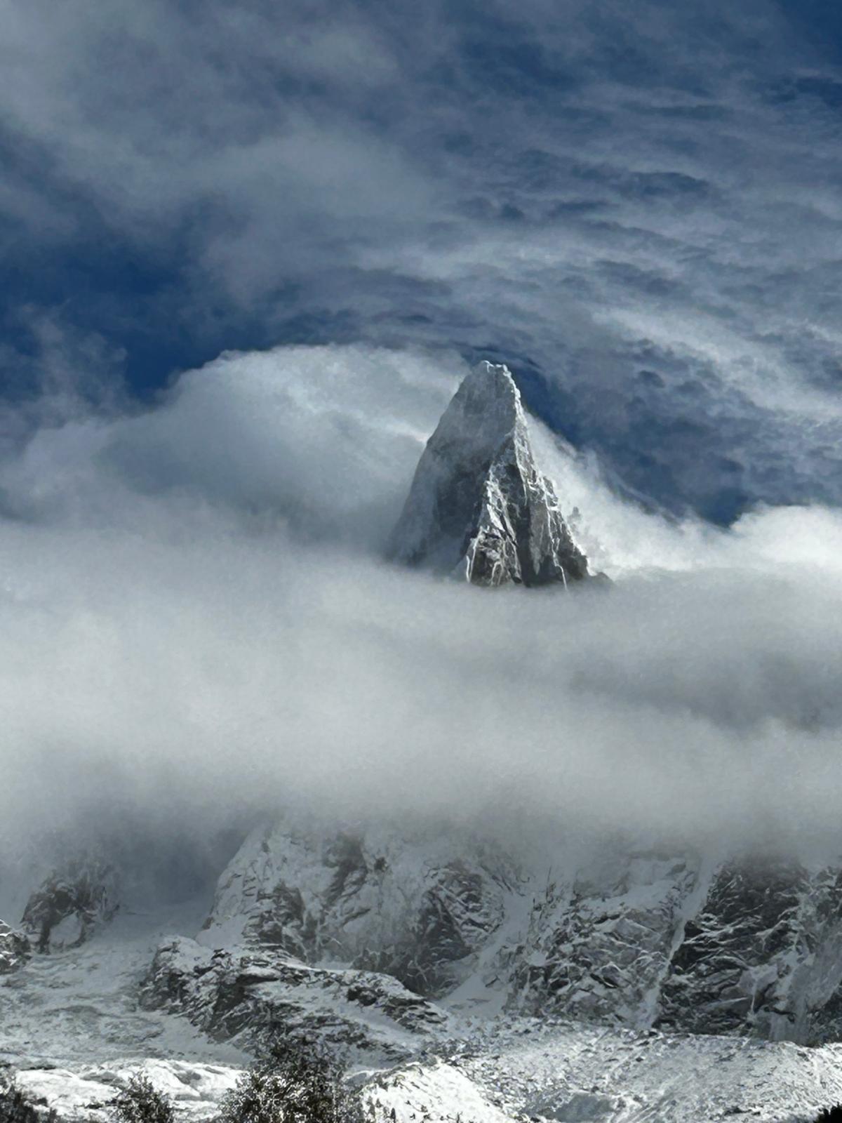 A mountain peak rising through mist